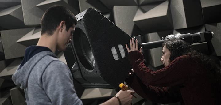 Two students working on a loudspeaker in an anechoic chamber