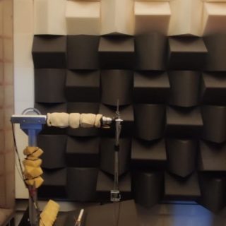 Copilot said: Acoustic testing chamber with sound-absorbing panels and measurement equipment for acoustics research.