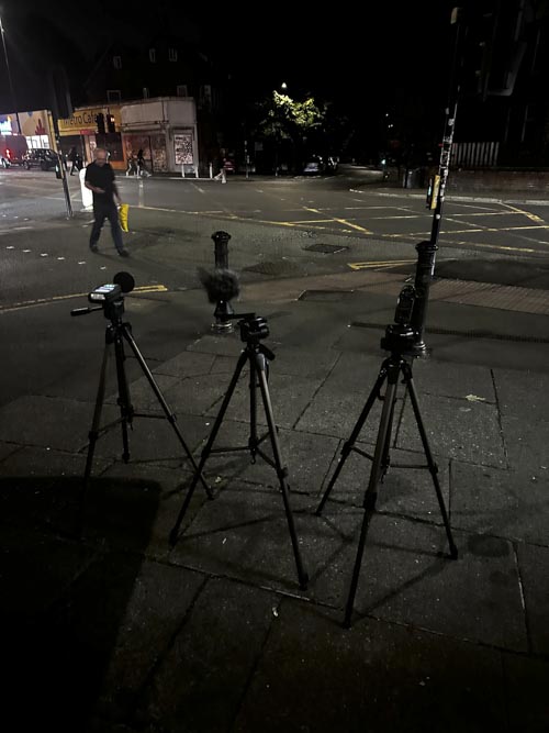 Sound level meter and microphone setup at side quiet street at night time