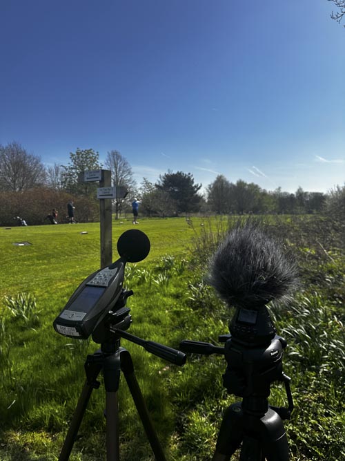 Sound level meter and microphone at side of golf course
