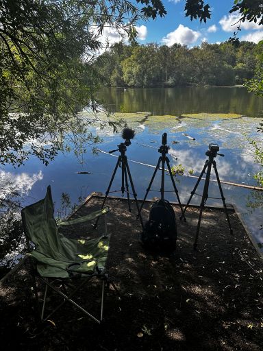 Sound level meter and microphone set up to measure sound at side of a fishing lake